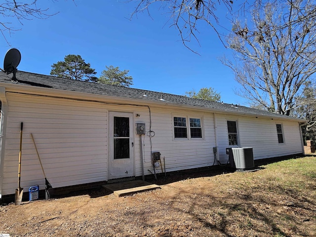 rear view of house with central AC unit