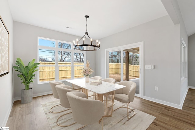 dining room with visible vents, a healthy amount of sunlight, and light wood-style floors