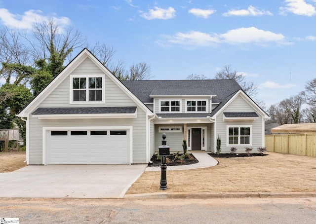 view of front of home featuring a garage, concrete driveway, roof with shingles, and fence