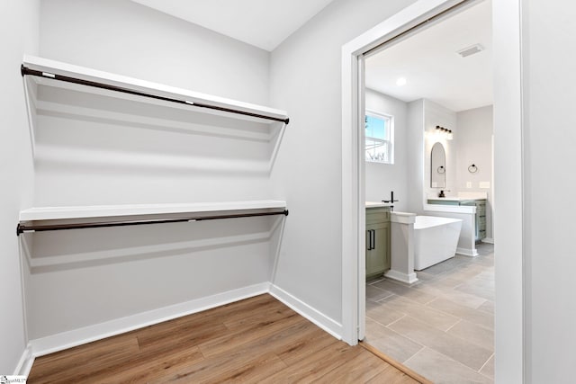 spacious closet with light wood-style floors