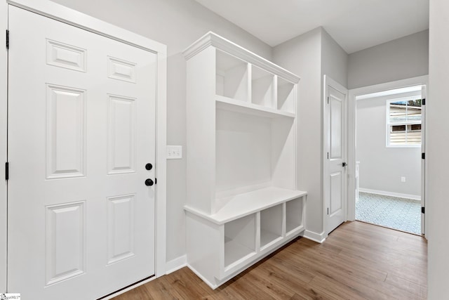 mudroom with wood finished floors and baseboards