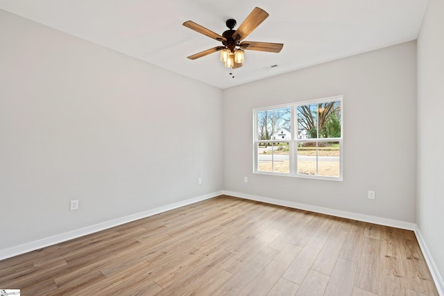 spare room with visible vents, ceiling fan, baseboards, and light wood-style floors