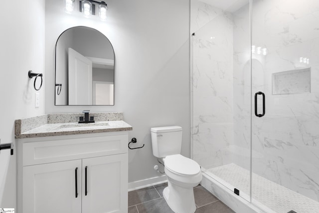 full bathroom featuring vanity, toilet, baseboards, and a marble finish shower