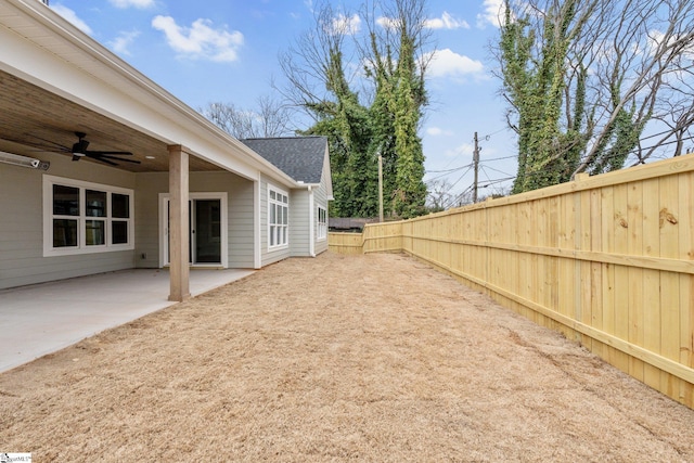 view of yard featuring a patio area, a fenced backyard, and ceiling fan