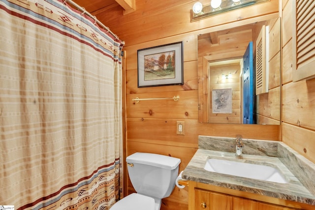 bathroom featuring vanity, wooden walls, toilet, and a shower with curtain