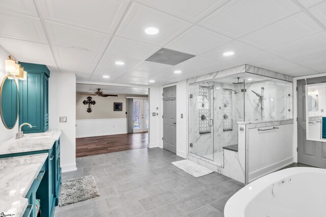 full bathroom featuring a ceiling fan, a whirlpool tub, recessed lighting, a marble finish shower, and vanity