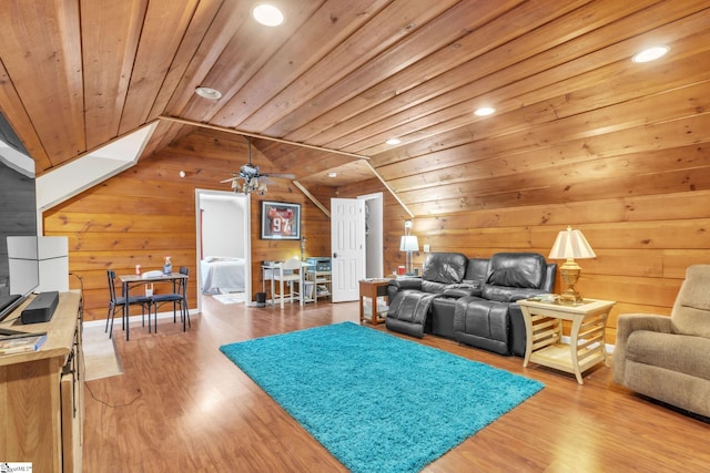 living area with vaulted ceiling, wood ceiling, and wood walls