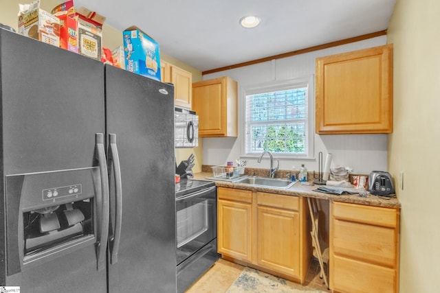 kitchen with light brown cabinetry, stainless steel refrigerator with ice dispenser, black electric range, a sink, and light countertops
