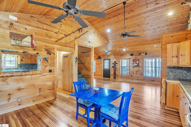 dining space featuring wooden ceiling, wooden walls, and a wealth of natural light