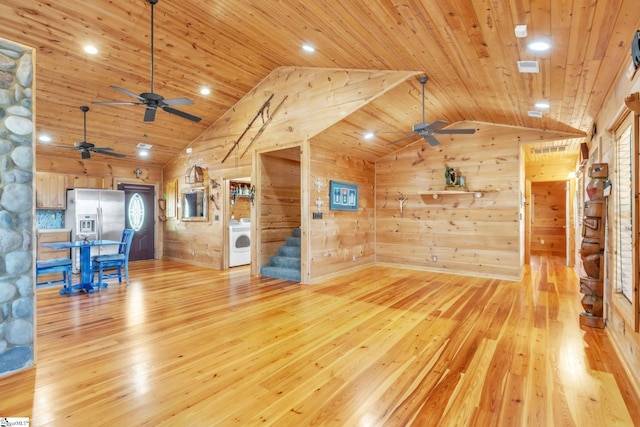 unfurnished living room with light wood finished floors, washer / dryer, wooden ceiling, and stairs