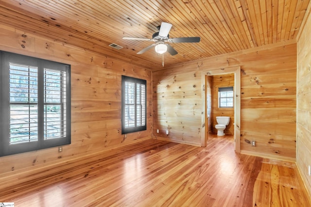 unfurnished room featuring a wealth of natural light, visible vents, wood ceiling, and light wood-type flooring