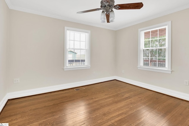 unfurnished room featuring hardwood / wood-style floors, baseboards, and ornamental molding