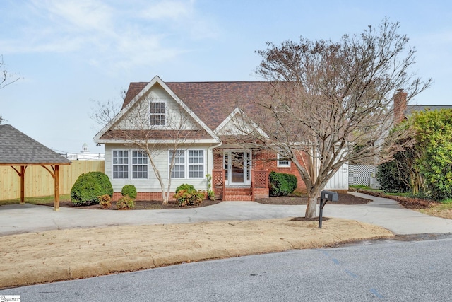 view of front of home with fence and driveway