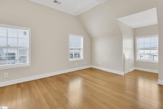 additional living space featuring visible vents, baseboards, lofted ceiling, and light wood-style floors