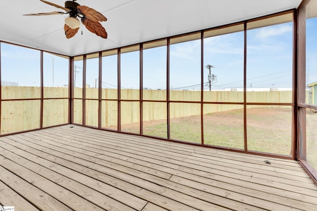 unfurnished sunroom with a ceiling fan