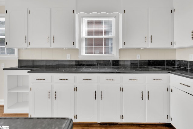 kitchen featuring open shelves, white cabinets, and plenty of natural light