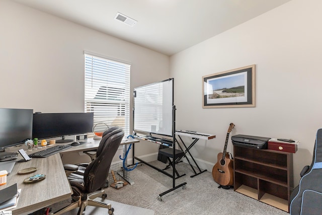 carpeted office space featuring visible vents and baseboards