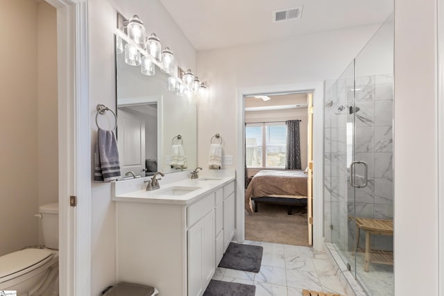 ensuite bathroom featuring visible vents, marble finish floor, a stall shower, and a sink