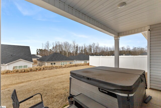 view of yard featuring fence and a hot tub