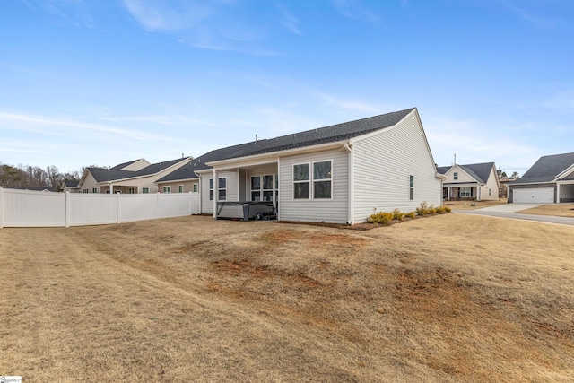 rear view of house featuring fence