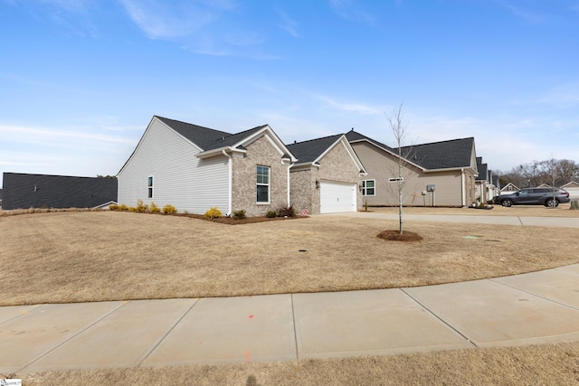 ranch-style house with brick siding, a garage, and driveway