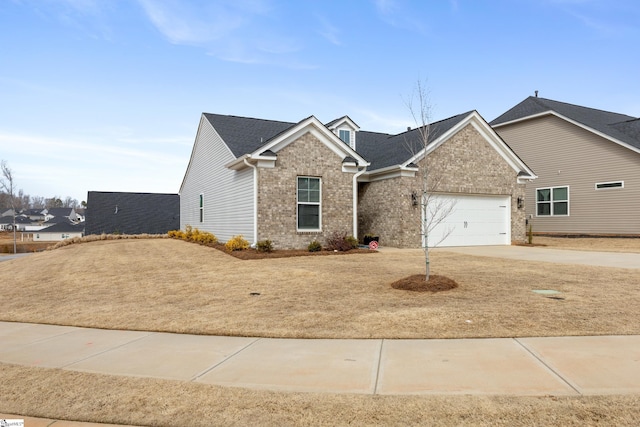 view of front of home featuring brick siding, an attached garage, and concrete driveway