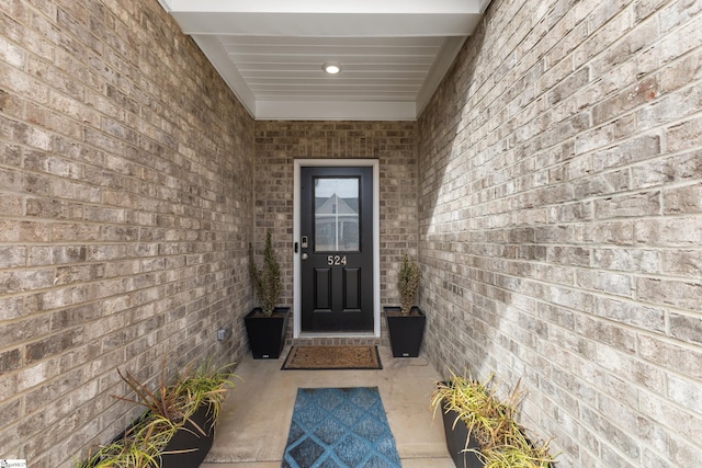 property entrance featuring brick siding