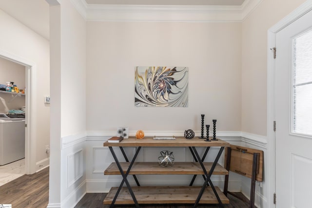 interior space with a wealth of natural light, wainscoting, dark wood finished floors, and washer / clothes dryer