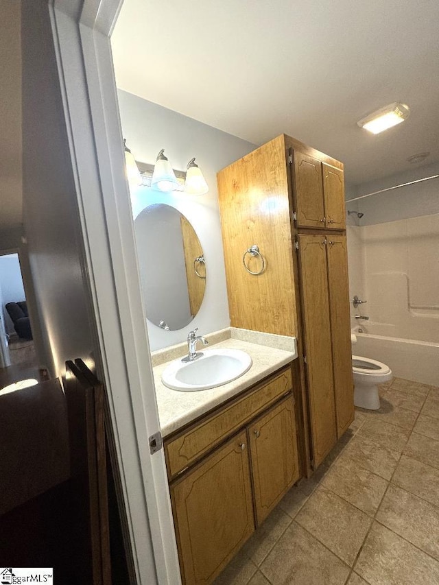 bathroom with vanity,  shower combination, toilet, and tile patterned floors