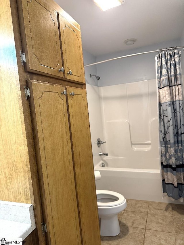 bathroom with tile patterned flooring, toilet, and shower / tub combo