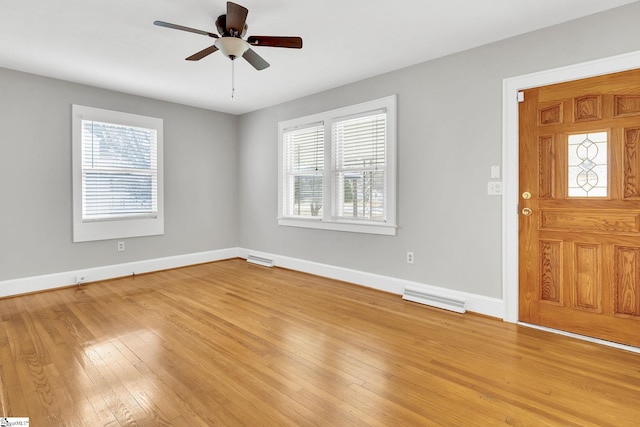 foyer with light wood-style floors, visible vents, and baseboards