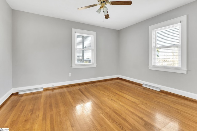 unfurnished room with light wood-style floors, baseboards, and visible vents