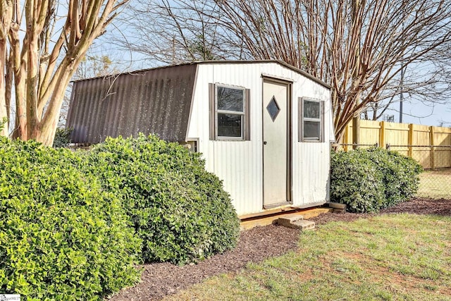 view of shed featuring fence