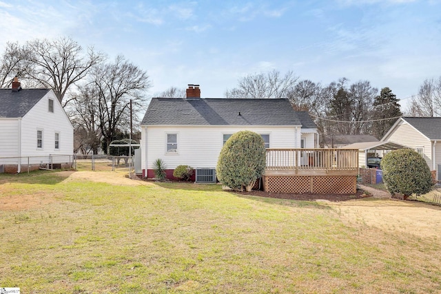 rear view of house featuring fence, central air condition unit, a chimney, a yard, and a deck