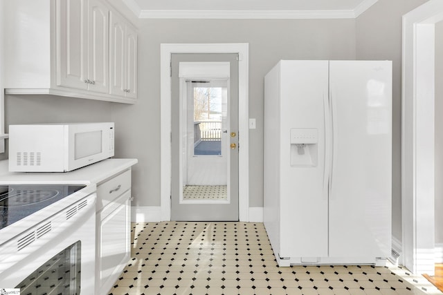 kitchen featuring white appliances, ornamental molding, light countertops, and white cabinetry