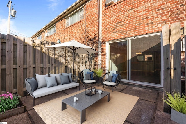 view of patio / terrace with an outdoor living space and fence