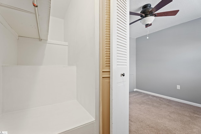 bathroom with a ceiling fan and baseboards