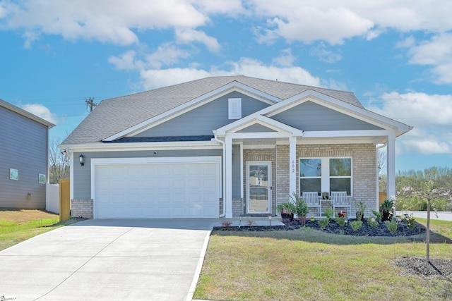 view of front of property with driveway, a porch, a front lawn, a garage, and brick siding