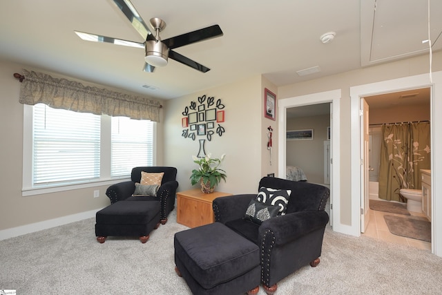 living area featuring tile patterned flooring, visible vents, ceiling fan, attic access, and carpet floors