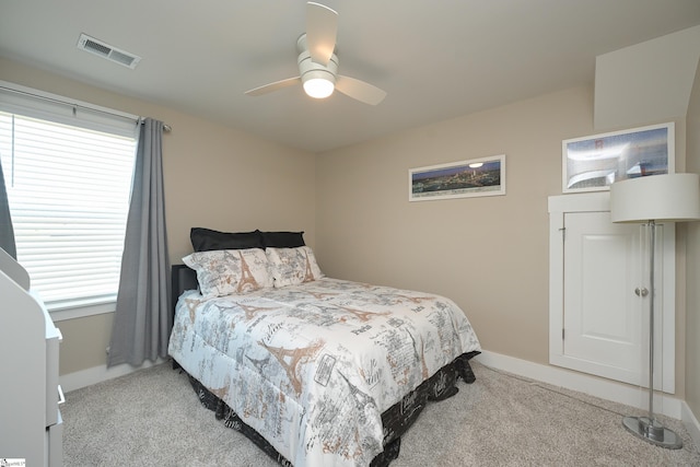 bedroom with light carpet, visible vents, baseboards, and a ceiling fan