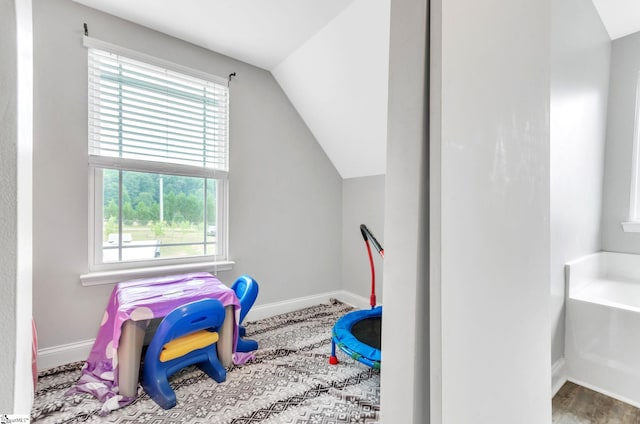 rec room featuring vaulted ceiling and baseboards