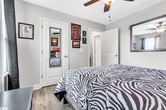 bedroom with light wood finished floors and ceiling fan