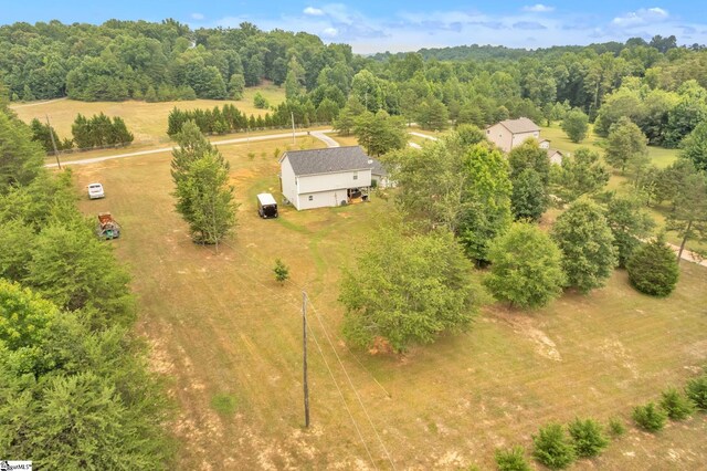 drone / aerial view featuring a rural view and a forest view