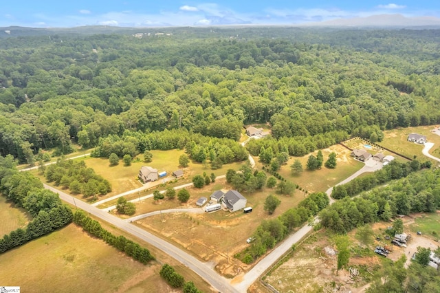 birds eye view of property with a rural view and a wooded view