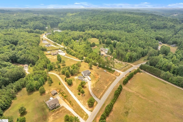 drone / aerial view with a view of trees and a rural view