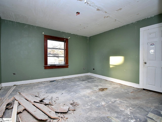 unfurnished room featuring baseboards