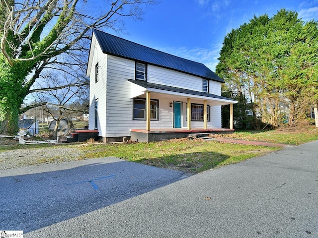 view of front facade featuring metal roof and covered porch