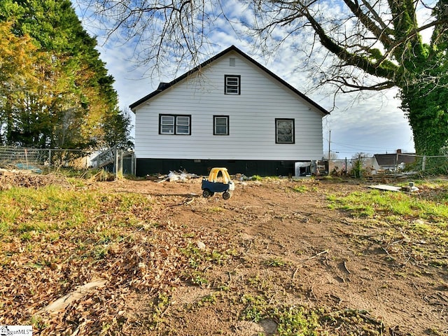 view of side of home with fence