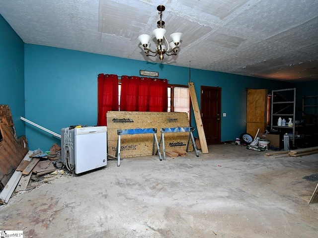 unfurnished dining area with concrete flooring and a chandelier