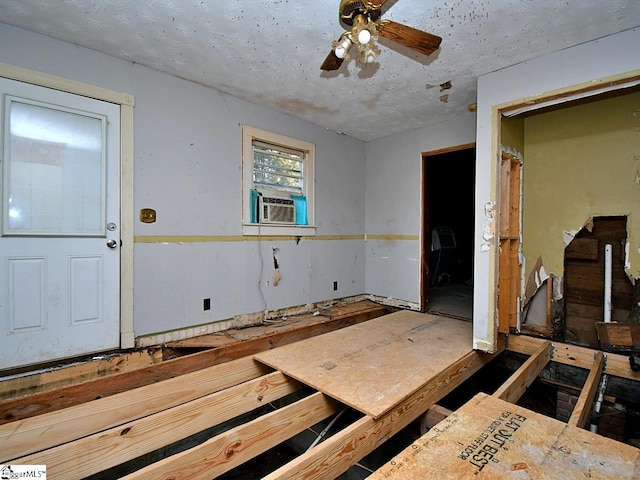 interior space with cooling unit and ceiling fan